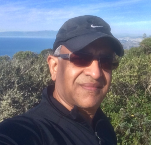 Headshot of Raj Bhargava (DCI 2015) with ocean in background.