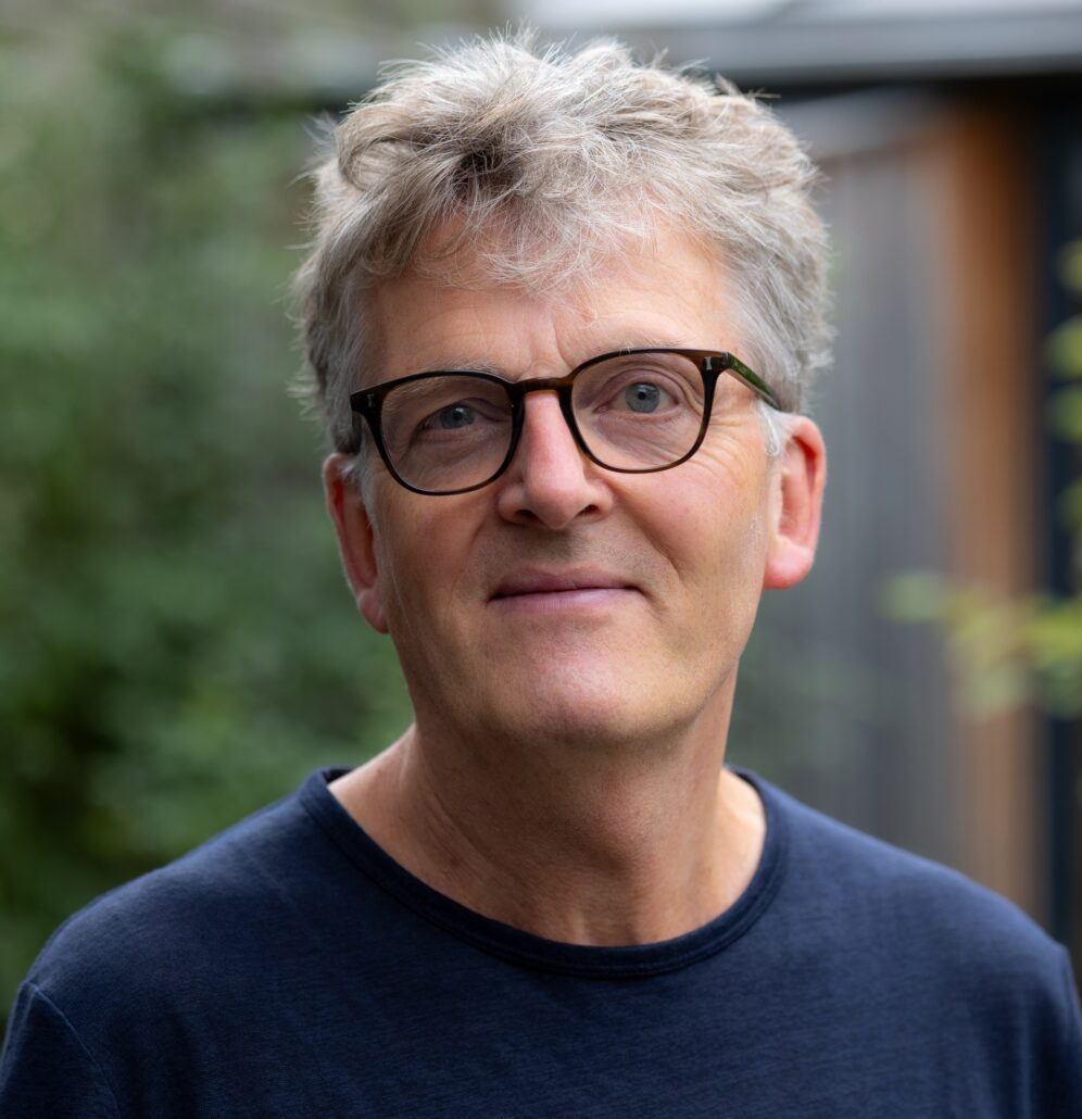 Headshot of Richard Ireland, DCI Fellow 2025. Man with grey hair and glasses wearing navy blue sweater.