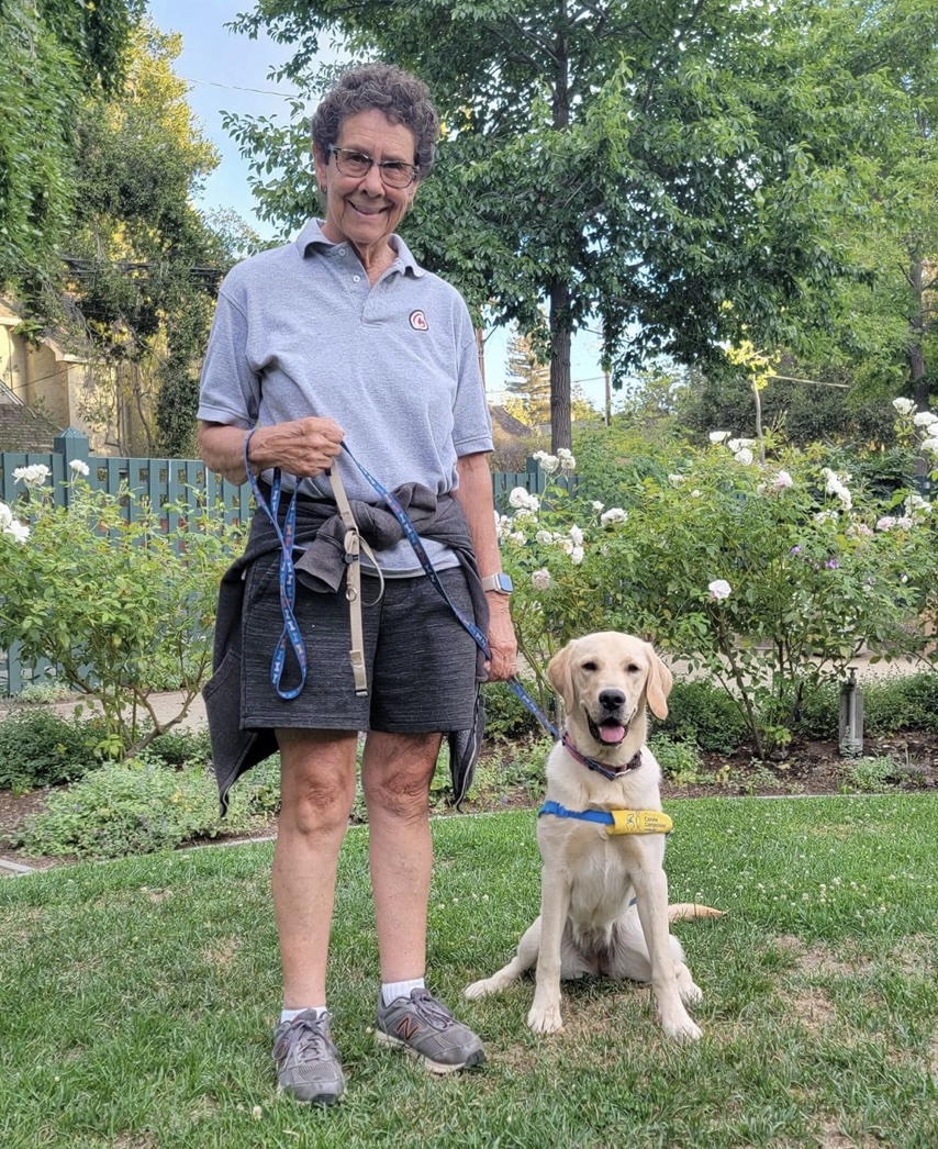 Monica Colandres (DCI 2015) standing next to her dog, Paprika.
