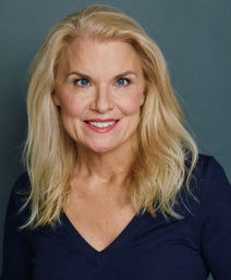 Blonde woman wearing blue V-neck top.
