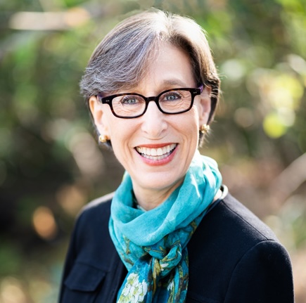 Tina_Seelig_Crop DCI Faculty Mentor Tina Seelig short hair glasses long scarf blue and green<br />